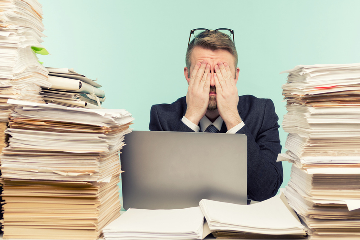 Close-up image of a stressful businessman tired from his work on the foreground - image